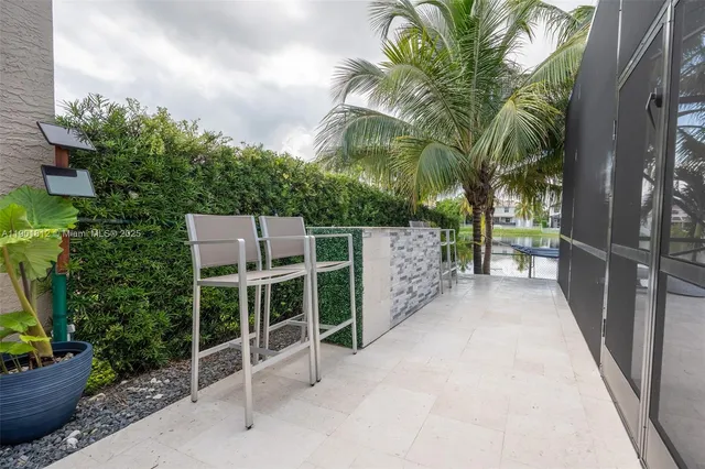 a view of a swimming pool with a garden and patio