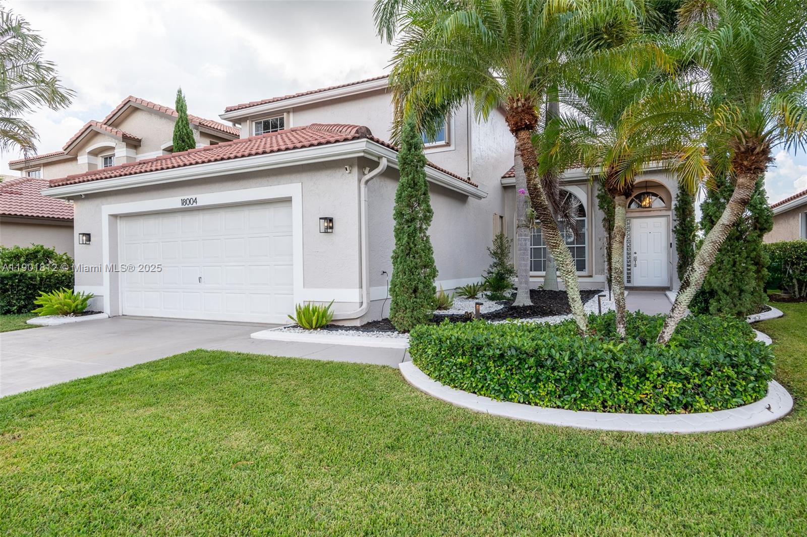18004 Southwest 20th Street Miramar, FL 33029 - Photo 5 of 49 a view of a house with a small yard plants and palm trees