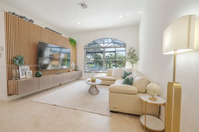 a living room with furniture and a large window