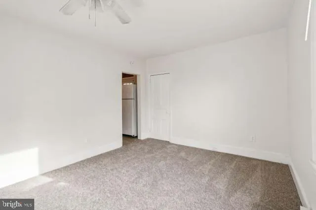 an empty room with windows and closet