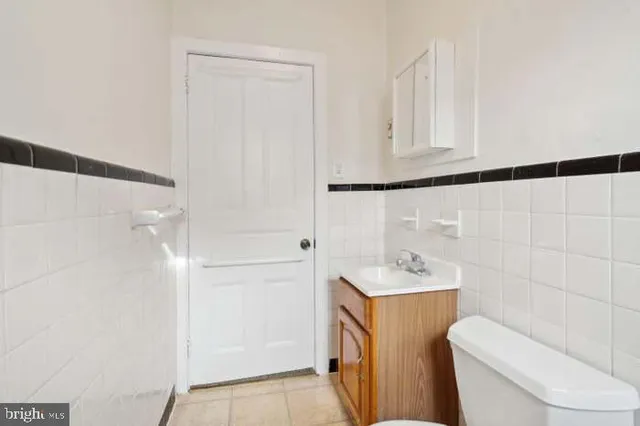 a view of a brick house with a small yard