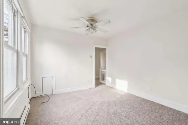 a bedroom with bed and window