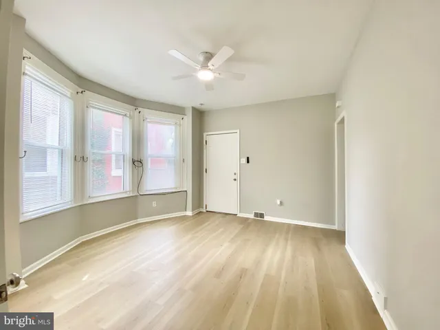 a view of an empty room with closet and a window