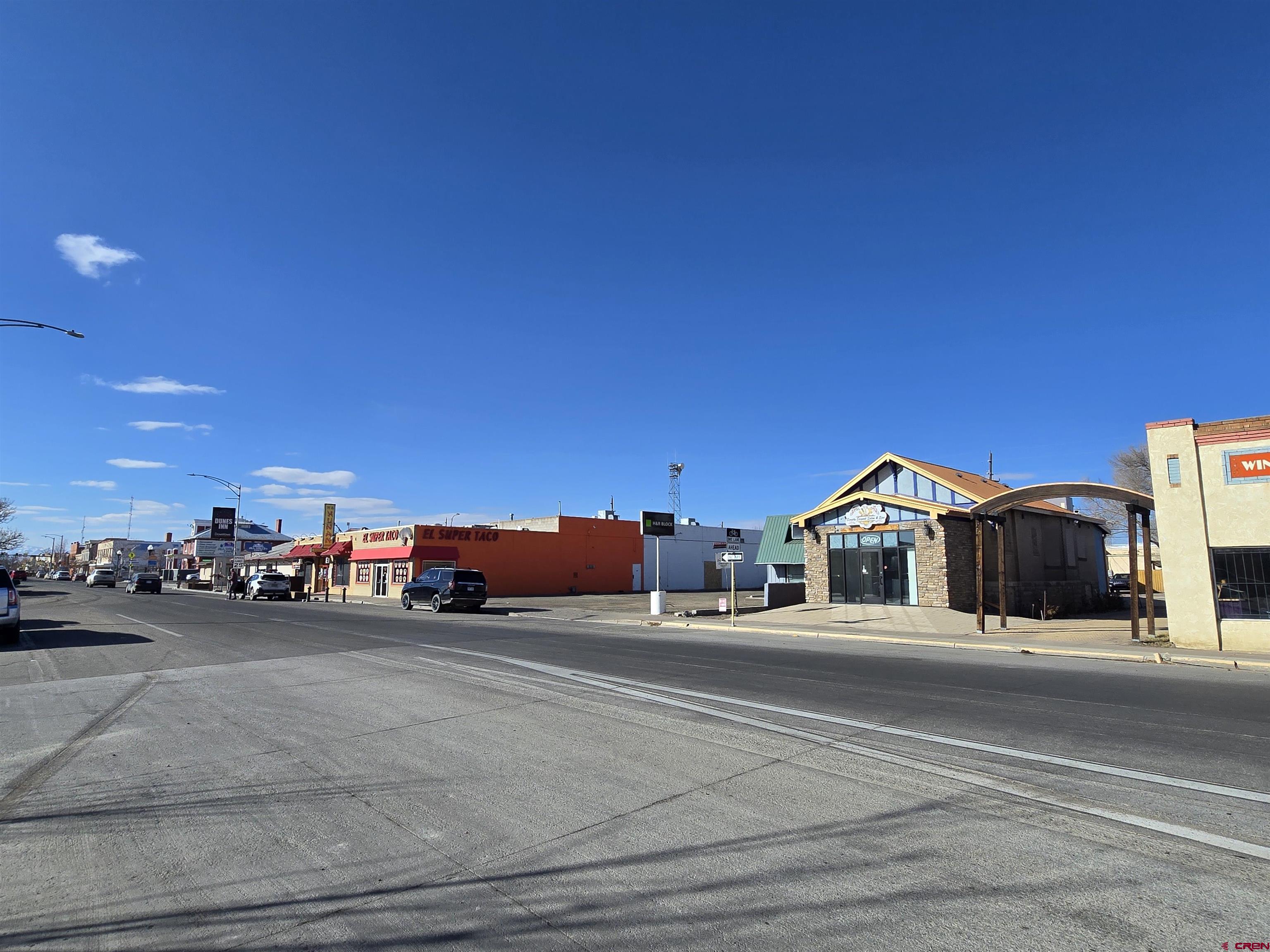 407 Main Street Alamosa, CO 81101 - Photo 2 of 13 a view of street with parked cars