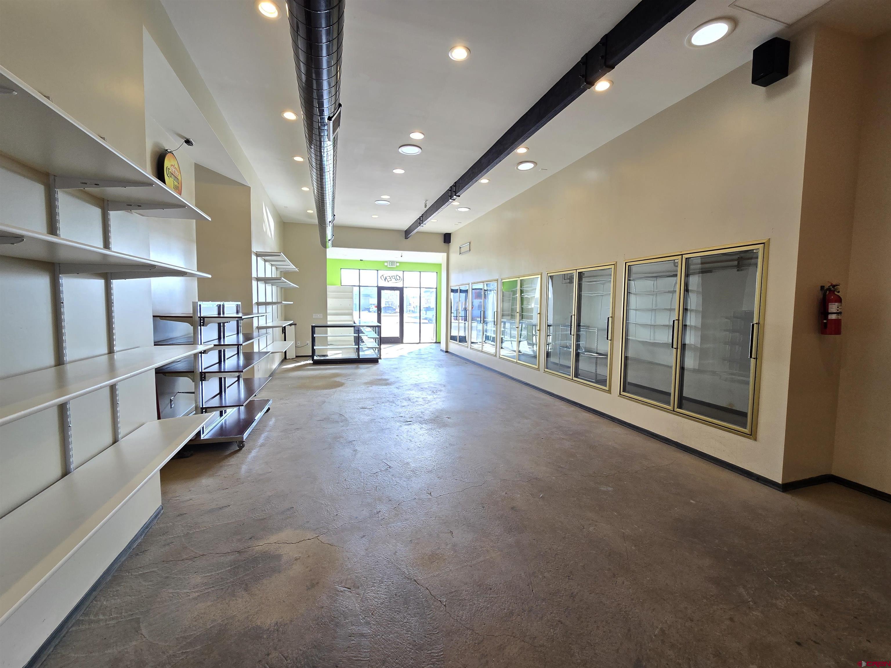 407 Main Street Alamosa, CO 81101 - Photo 4 of 13 a view of an empty room with stairs
