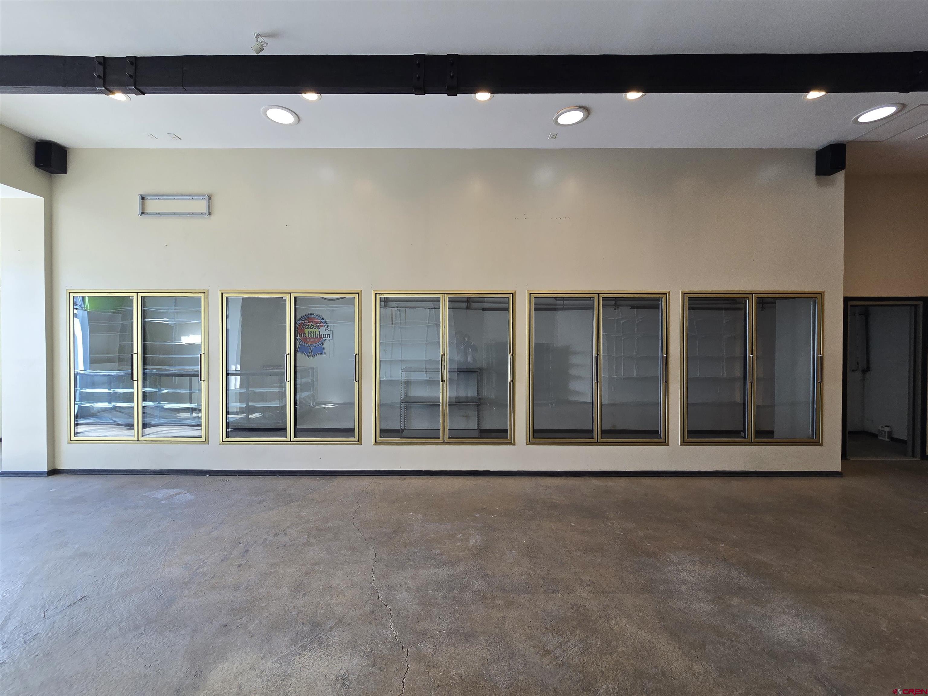 407 Main Street Alamosa, CO 81101 - Photo 5 of 13 a view of an empty room with a window