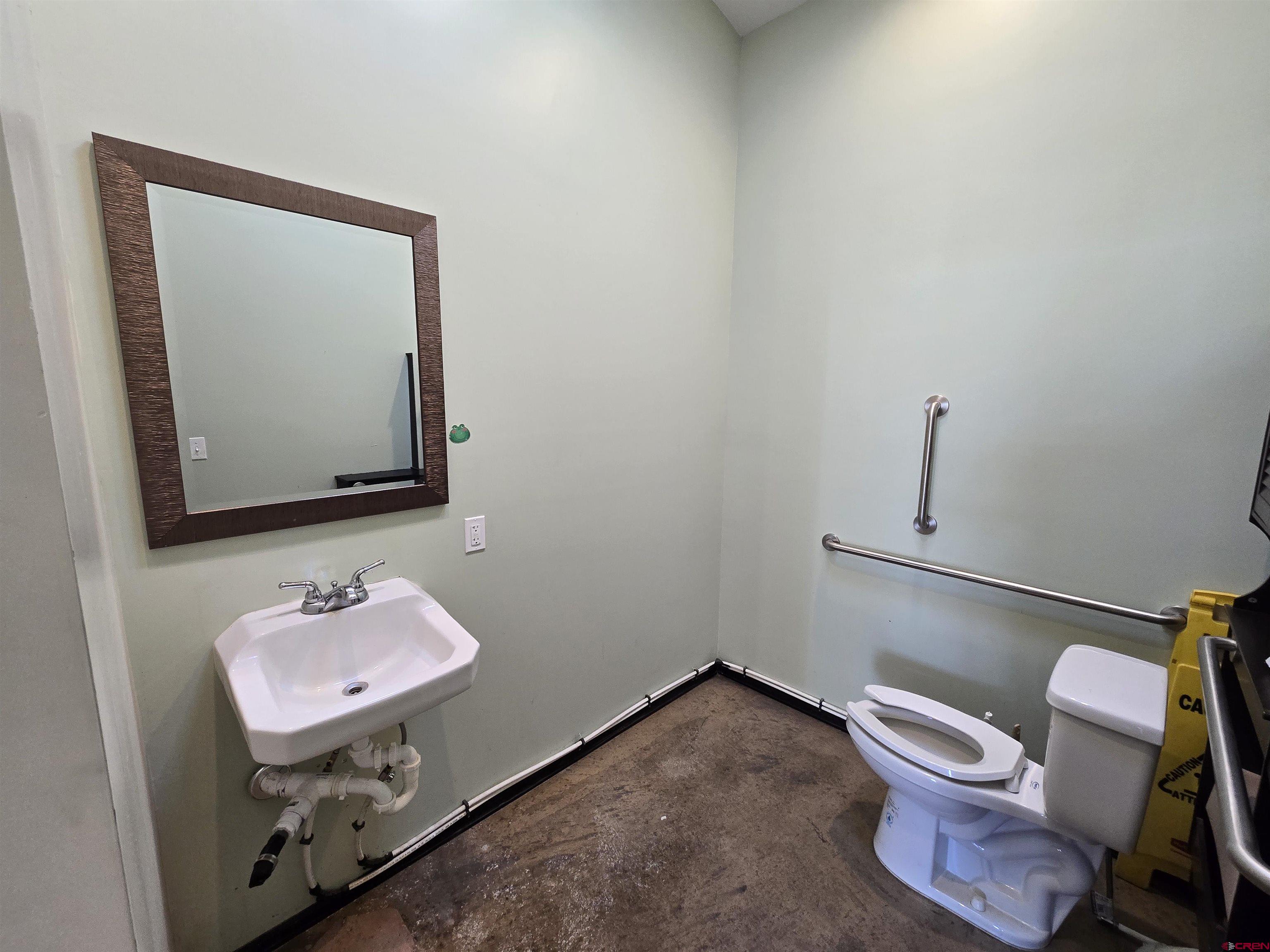 407 Main Street Alamosa, CO 81101 - Photo 9 of 13 a bathroom with a sink toilet and mirror