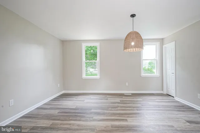 wooden floor in an empty room with window