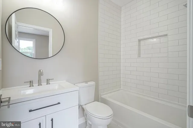 a bathroom with a sink toilet and a mirror