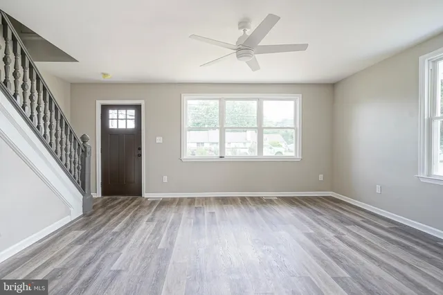 wooden floor in an empty room with a window