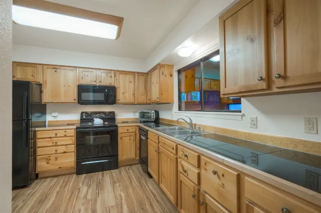 a kitchen with stainless steel appliances granite countertop a sink and cabinets