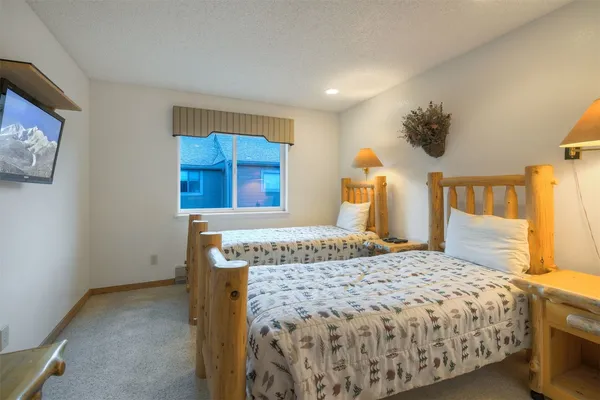 a bedroom with a bed and a painting on the wall