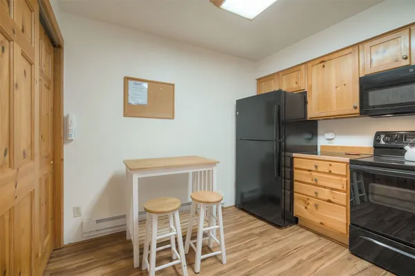 a kitchen with stainless steel appliances a refrigerator and a stove top oven