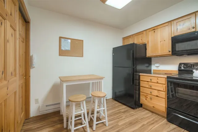 a kitchen with stainless steel appliances a refrigerator and a stove top oven