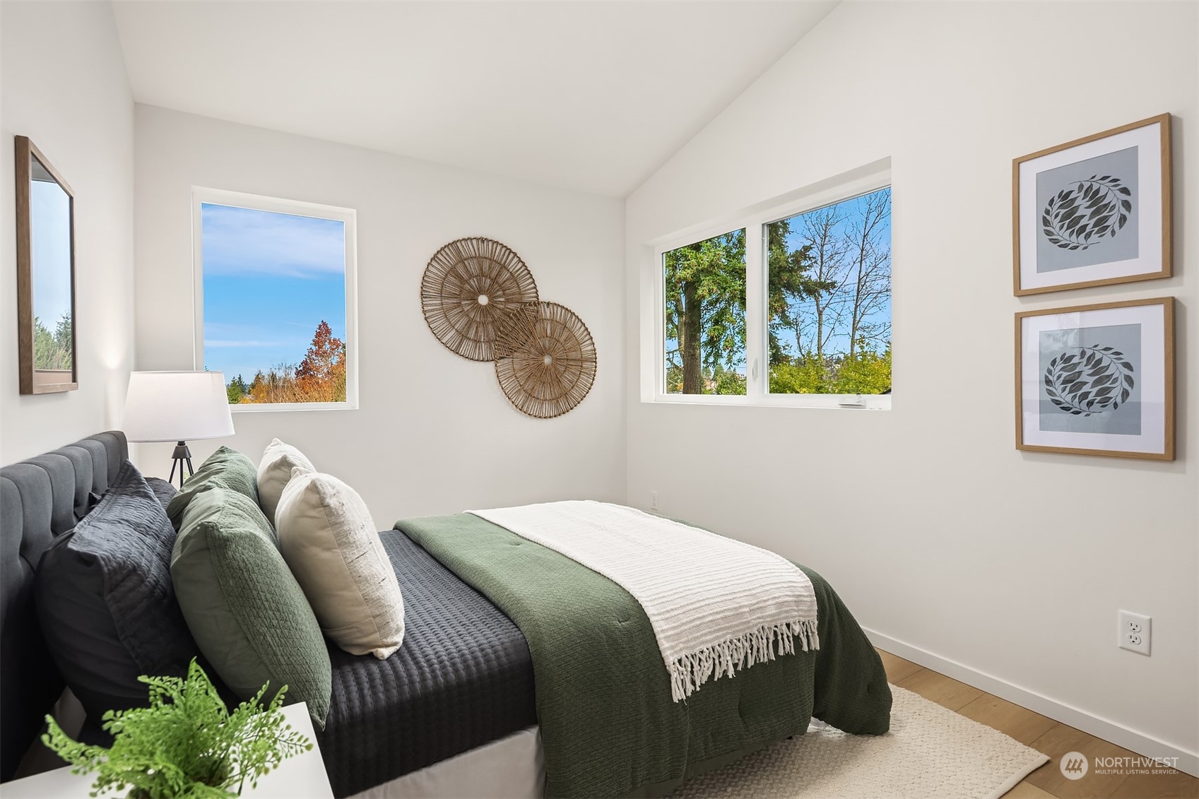 3304 49th Avenue Southwest Seattle, WA 98116 - Photo 17 of 34 a bedroom with a bed and a painting on the wall
