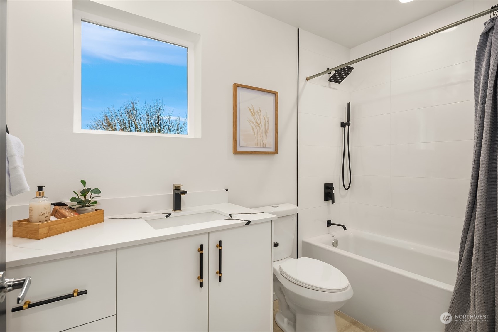 3304 49th Avenue Southwest Seattle, WA 98116 - Photo 18 of 34 a bathroom with a sink a toilet and a bathtub