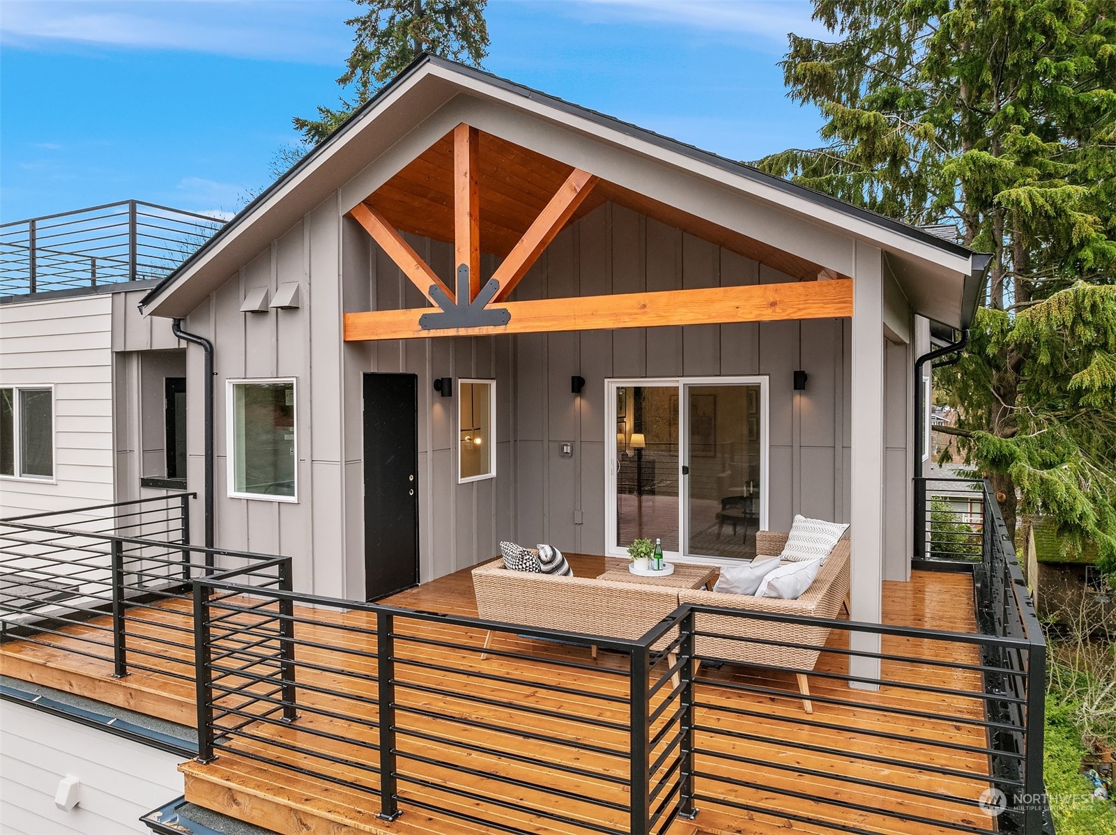 3304 49th Avenue Southwest Seattle, WA 98116 - Photo 27 of 34 a patio with a table and chairs and potted plants