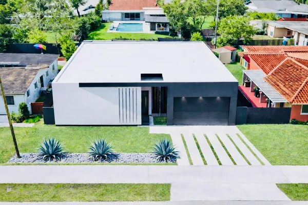 an aerial view of a house with a yard
