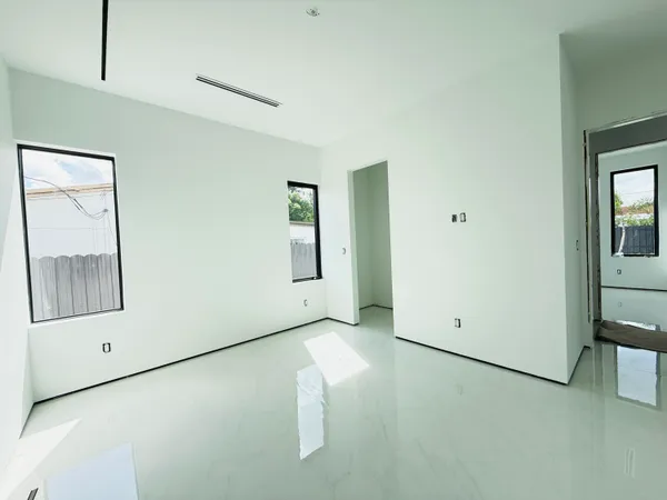 a view of room with window and refrigerator