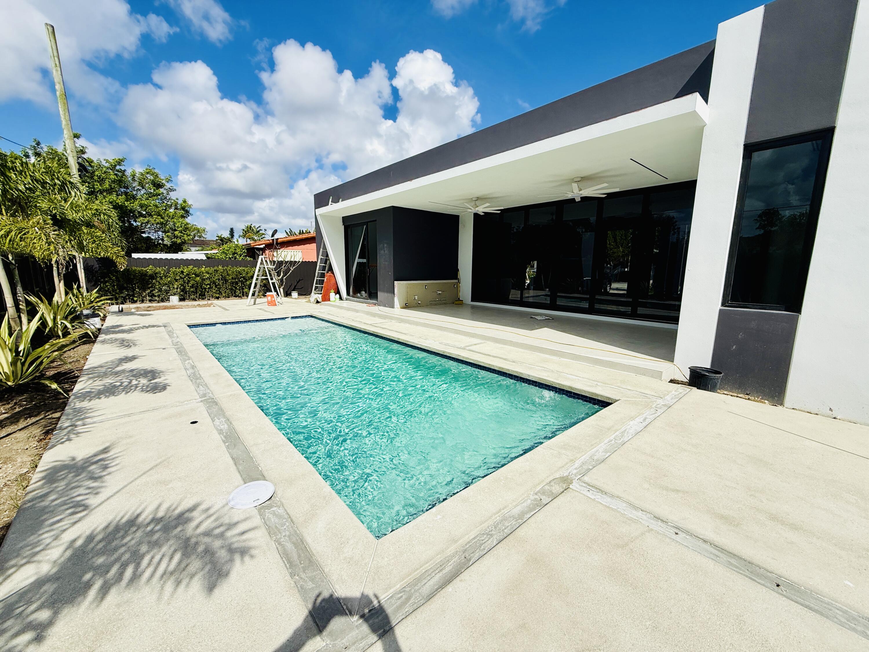 8966 Southwest 40th Terrace Miami, FL 33165 - Photo 35 of 40 a front view of a house with garden