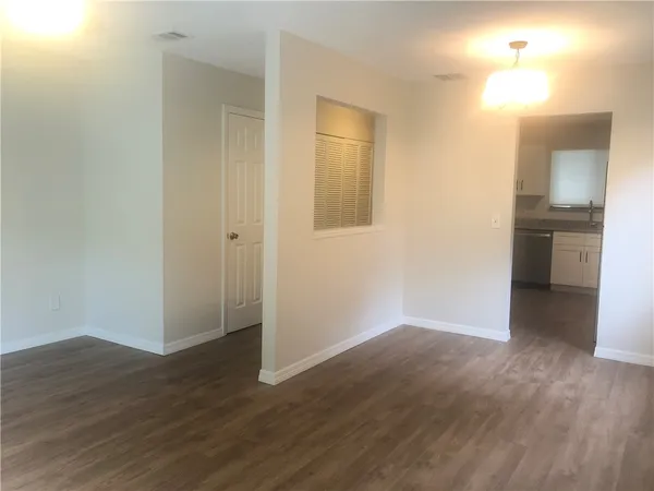 a view of a room with wooden floor