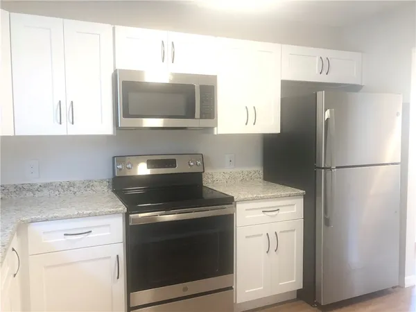 a kitchen with a stove microwave and refrigerator