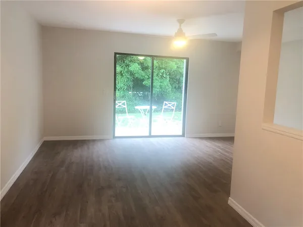 a view of a room with wooden floor and window