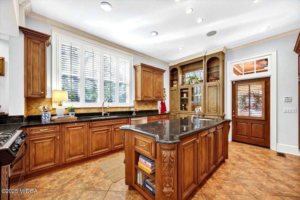 1158 Jackson Springs Road Macon, GA 31211 - Photo 14 of 42 a kitchen with stainless steel appliances granite countertop a sink and a stove