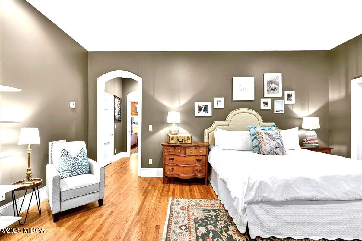 1158 Jackson Springs Road Macon, GA 31211 - Photo 22 of 42 a bedroom with a bed and wooden floor