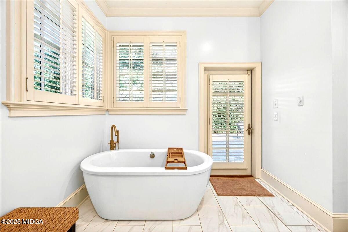 1158 Jackson Springs Road Macon, GA 31211 - Photo 24 of 42 a white bath tub sitting in a bathroom next to a window