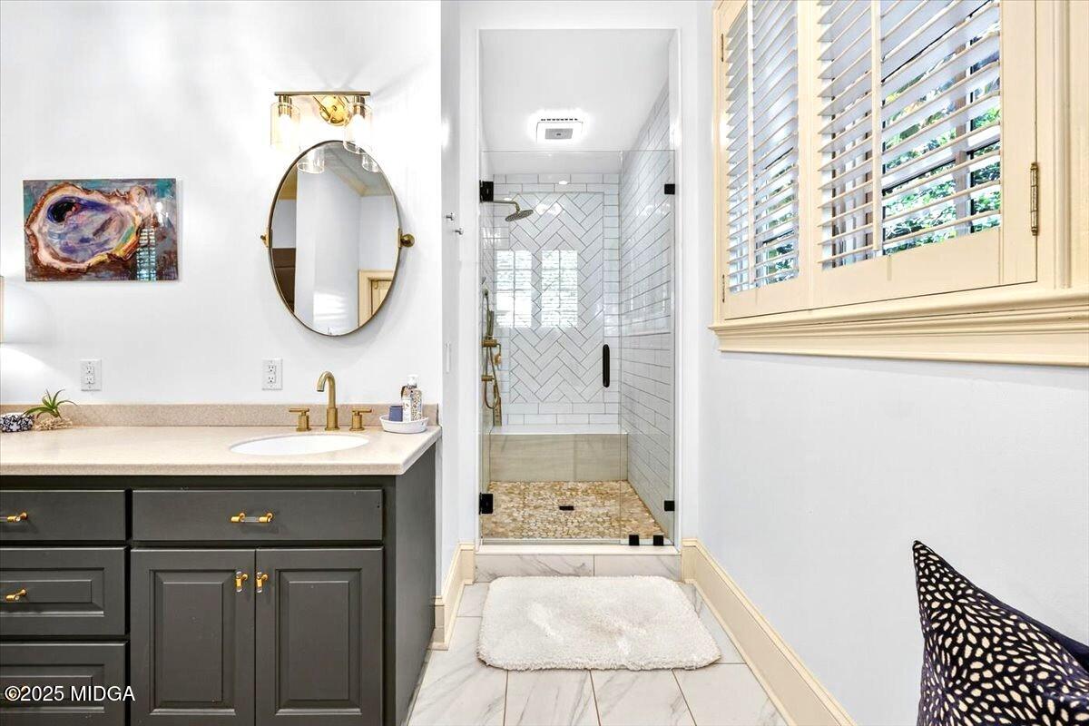 1158 Jackson Springs Road Macon, GA 31211 - Photo 25 of 42 a bathroom with a sink and a mirror