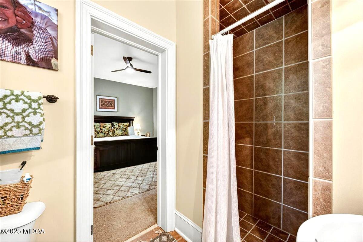 1158 Jackson Springs Road Macon, GA 31211 - Photo 28 of 42 a bathroom with a toilet and shower