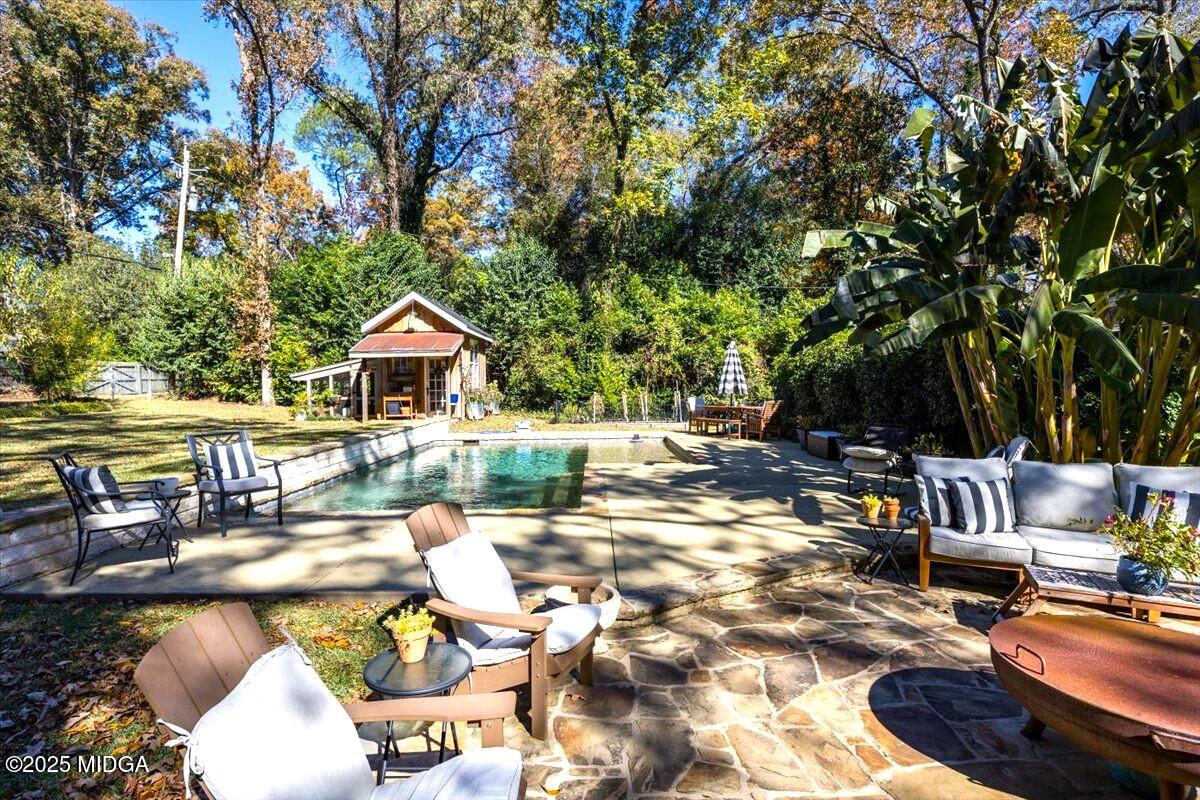 1158 Jackson Springs Road Macon, GA 31211 - Photo 36 of 42 a swimming pool with outdoor seating and yard