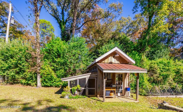 a view of a house with backyard porch and sitting area