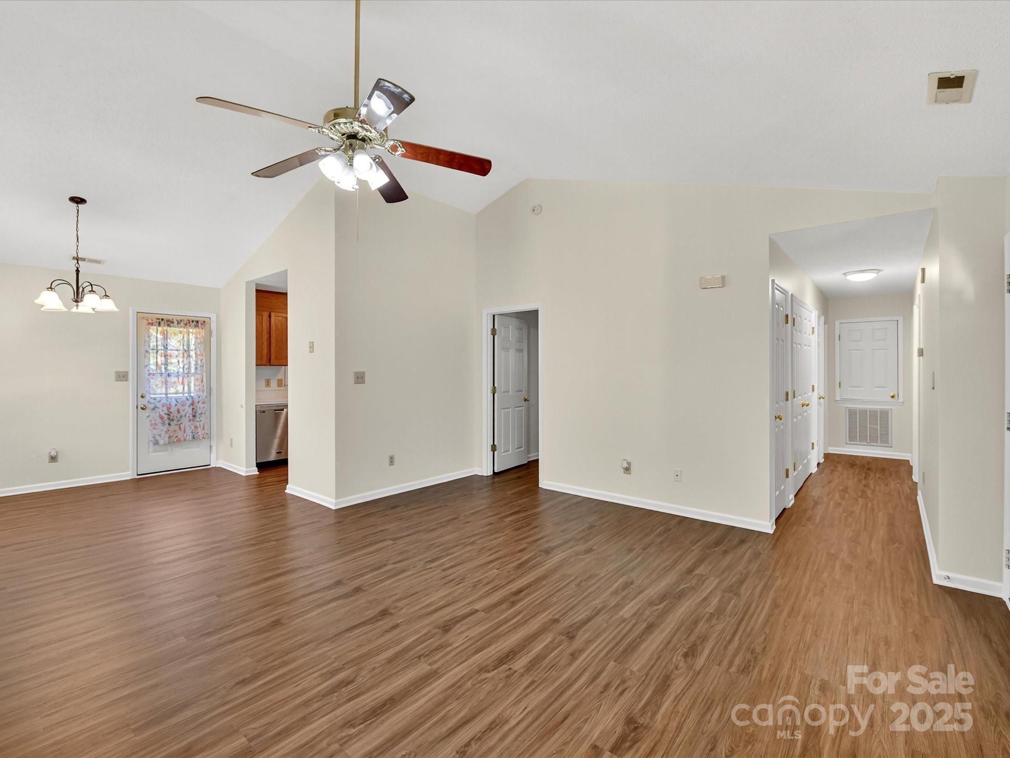 2407 Ruben Road Monroe, NC 28112 - Photo 8 of 33 a view of an empty room with wooden floor and a ceiling fan