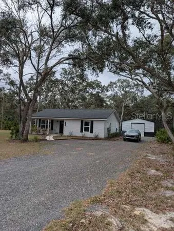 a front view of house with yard and trees