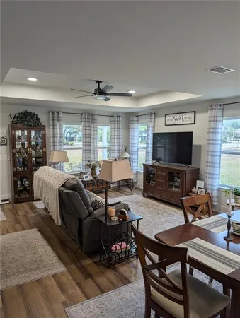 a spacious bedroom with a bed a couch and large windows