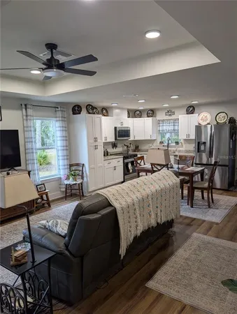 a kitchen with kitchen island a dining table and chairs