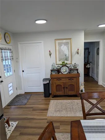 a bathroom with a granite countertop toilet a sink and a mirror