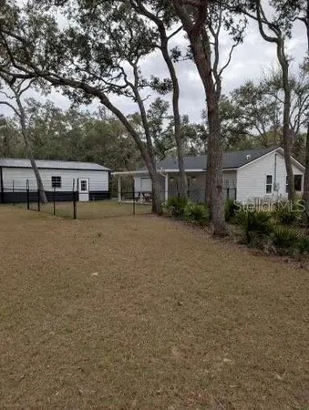 a view of a house with outdoor space and sitting area