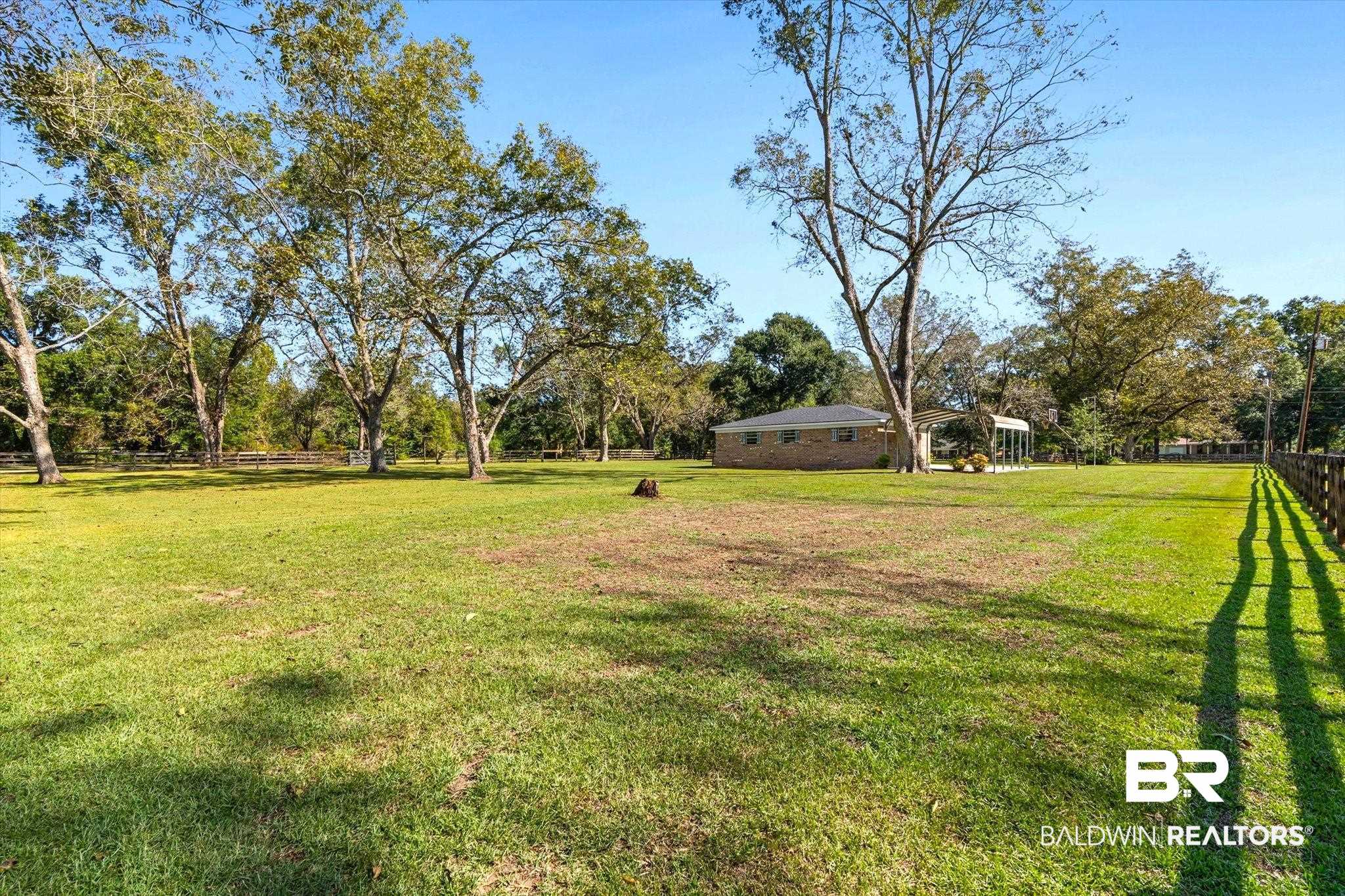 8090 Murray Hill Road Irvington, AL 36544 - Photo 33 of 40 View of yard with a carport and view of wooded area