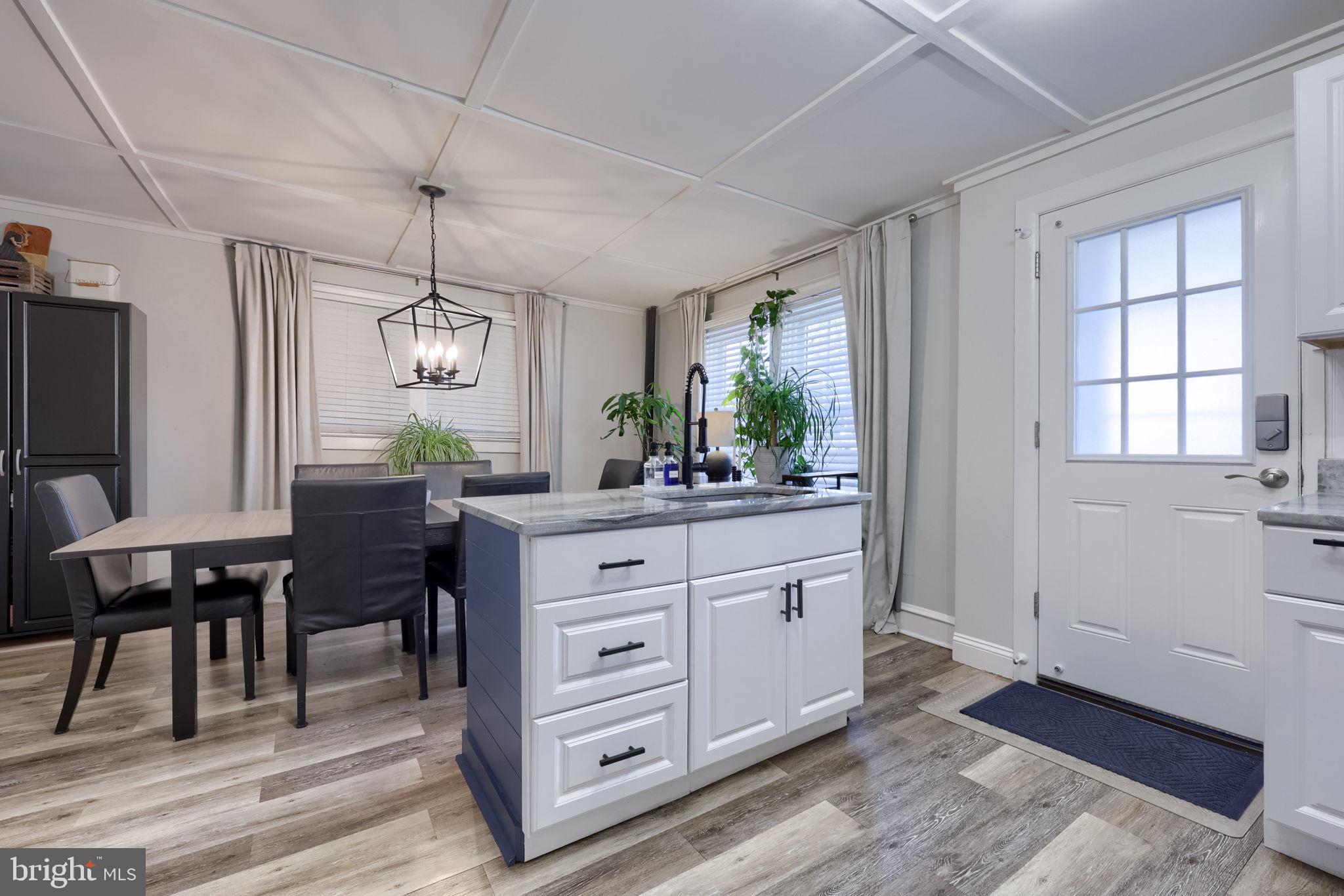 827 3rd Street Lancaster, PA 17603 - Photo 20 of 37 a view of dining room and livingroom with furniture wooden floor a rug and a chandelier