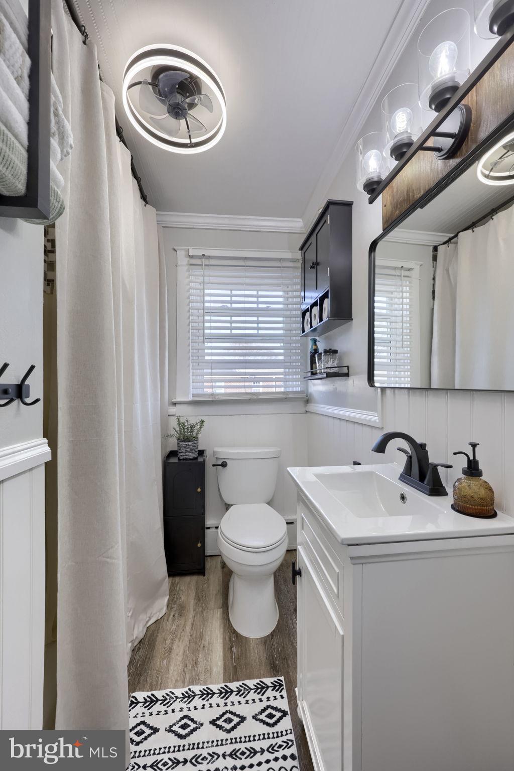 827 3rd Street Lancaster, PA 17603 - Photo 29 of 37 a bathroom with a sink a toilet and a mirror