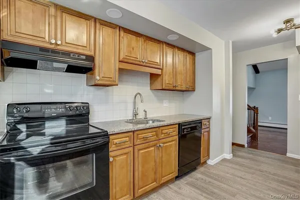 a kitchen with stainless steel appliances granite countertop a stove and a microwave