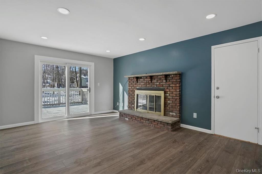 36 Ironworks Road Monroe, NY 10950 - Photo 19 of 37 Unfurnished living room with a brick fireplace, wood finished floors, and recessed lighting