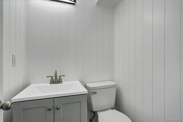 a bathroom with a sink a toilet and vanity