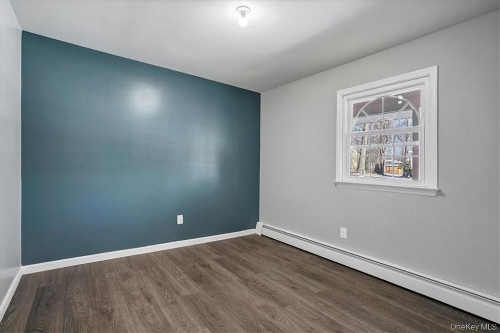 36 Ironworks Road Monroe, NY 10950 - Photo 22 of 37 Unfurnished room featuring a baseboard heating unit and dark wood finished floors
