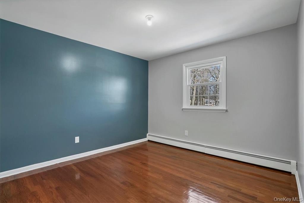36 Ironworks Road Monroe, NY 10950 - Photo 27 of 37 Unfurnished room with a baseboard heating unit and dark wood-type flooring