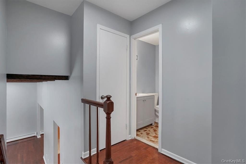 36 Ironworks Road Monroe, NY 10950 - Photo 29 of 37 Hall with an upstairs landing, dark wood finished floors, and a baseboard heating unit