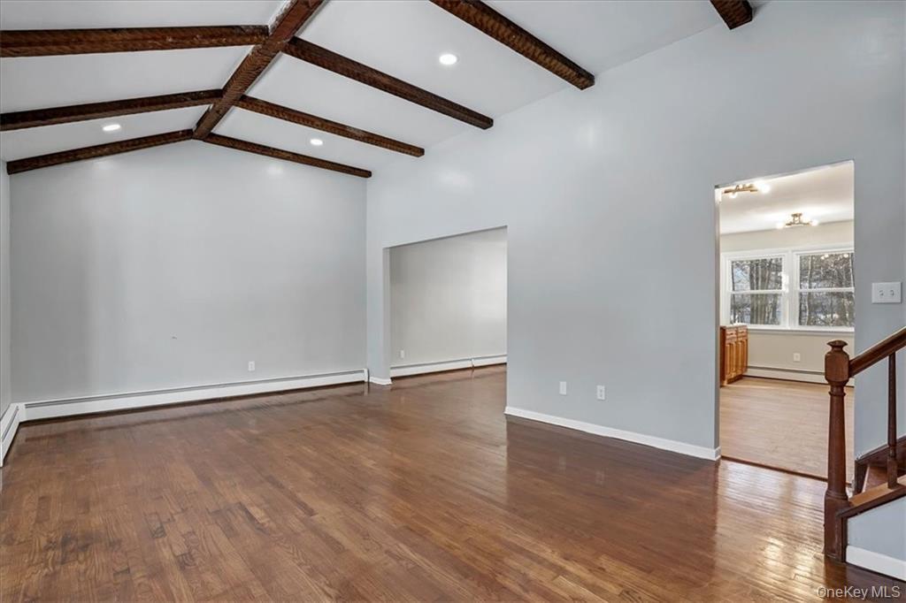 36 Ironworks Road Monroe, NY 10950 - Photo 10 of 37 Spare room with dark wood-type flooring, stairway, a baseboard radiator, baseboard heating, and recessed lighting